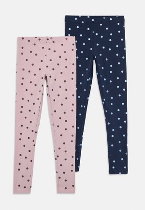Two pairs of children's leggings laid flat, one pink with dark purple polka dots, the other navy blue with light blue polka dots.