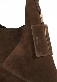 Dark brown suede handbag with attached small zippered pouch and gold-tone clasp on a white background.