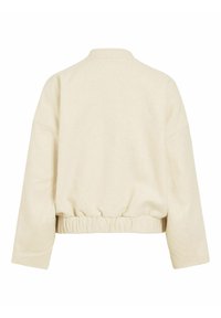 Veste crème à manches longues avec taille élastique, col montant et design simple au dos, vue de dos sur fond blanc.