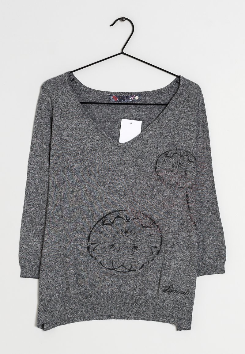 Gray knit sweater with a V-neck, three-quarter sleeves, floral cutout design, and a side pocket. Features a hanging tag and rounded hem.