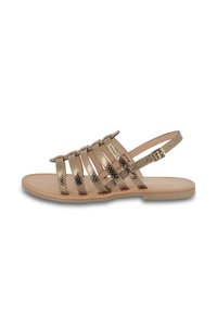 Gold metallic strappy sandals with a flat sole, featuring multiple horizontal straps and an adjustable buckle at the ankle.
