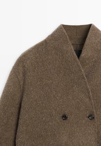 Brown woolen double-breasted coat with wide lapel collar and two visible black buttons on a white background.
