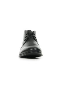 Chaussure habillée noire en cuir avec un bout arrondi, un design épuré, et cinq œillets pour les lacets. Texture lisse et semelle en caoutchouc discrète.