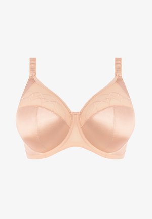 Soutien-gorge sous-vêtement beige avec des bonnets en satin lisse, des panneaux en tulle transparent et des coutures décoratives. Bretelles ajustables et un détail en nœud au centre.