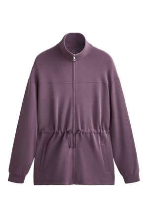 Violetti vetoketjullinen takki korkealla kauluksella, nyörikiinnitteinen vyötärö ja sivutaskut; valmistettu sileästä, kevyestä kankaasta.