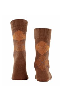 Calze marroni con un motivo a maglia testurizzato, caratterizzate da un design argyle con accenti arancioni e blu, con polsini a coste e lunghezza fino a metà polpaccio.