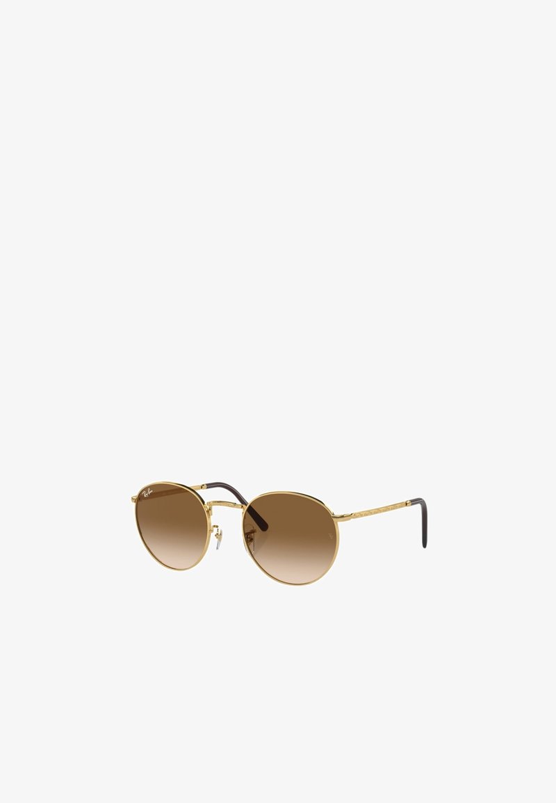 Occhiali da sole rotondi con montatura in metallo dorato, lenti a gradiente marroni e dettagli scuri marroni sulle tempie. Presentano un motivo testurizzato sulle aste.
