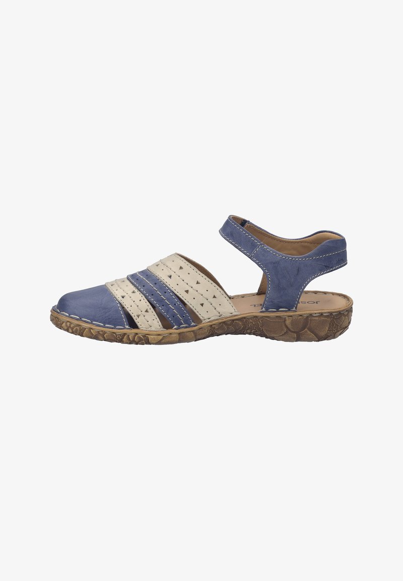Sandale en cuir bleu et beige avec des lanières perforées, bride de cheville ajustable et semelle en caoutchouc marron texturée.