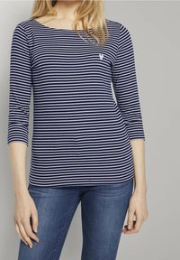 Navy and white striped long-sleeve top with a boat neckline and a small white logo on the chest. Soft fabric with a fitted design.