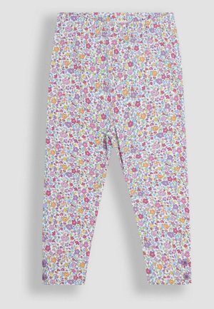 Leggings valmistettu joustavasta kankaasta, jossa on monivärinen kukkakuosi, johon kuuluu vaaleanpunaisia, violetit, oranssit ja vihreät sävyt valkoisella taustalla.