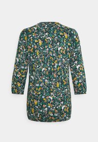 Blommig topp med trekvartsärmar, med en mörkgrön bakgrund och en livlig blandning av gula, vita och rosa blommor.