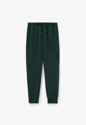 Dunkelgrüne Sweatpants aus weichem Baumwollmaterial. Elastischer Bund mit Kordelzug und schmal zulaufenden Bündchen. Zwei Seitentaschen, minimalistisches Design.