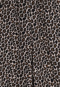 Leopard print fabric featuring a beige background with black and brown spots, smooth texture, and a repeating pattern throughout.