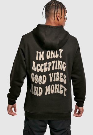 Black hoodie with a drawstring, featuring large light-colored text on the back that reads "I'm only accepting good vibes and money."