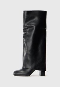 Black leather knee-high boots with a smooth texture, a rounded toe, and a chunky block heel. Features a draped design and minimalistic silhouette.