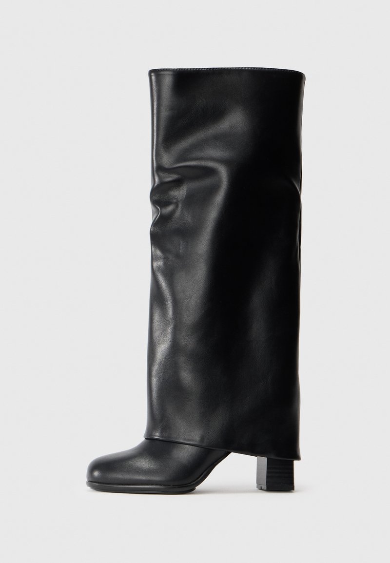 Black leather knee-high boots with a smooth texture, a rounded toe, and a chunky block heel. Features a draped design and minimalistic silhouette.