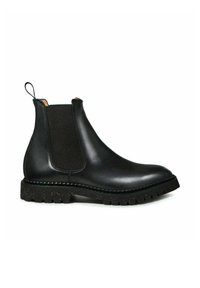 Bottes Chelsea en cuir noir avec panneaux latéraux élastiques, languette de tirage et semelle en caoutchouc texturée présentant un motif tacheté.