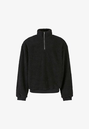 Must musta pullover kõrge kaelusega, pooltõmbe sulguriga, tekstuuriga kangas ning ribaga varrukad ja alläär. Mugav ja juhuslik disain.