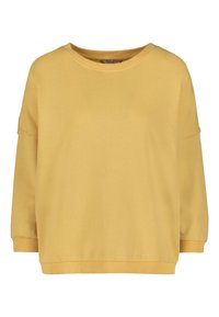 Sudadera amarilla de tejido suave, con cuello redondo, hombros caídos y puños acanalados, con un diseño de ajuste holgado.