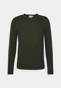 Mörkgrön långärmad tröja gjord av mjukt material, med rund halsringning och en liten "CK"-logotyp på bröstet.