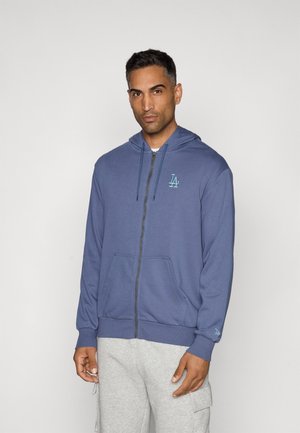 Blue zip-up hoodie made from soft fabric, featuring a front pocket and a small LA logo in teal. Attached hood with drawstrings.