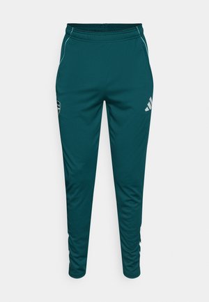 Pantaloni sportivi turchese realizzati in tessuto liscio e leggero. Presentano un design affusolato con dettagli bianchi e logo sulla coscia sinistra.