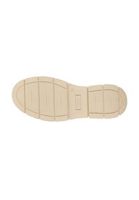 Zool van een schoen, licht beige van kleur, met een getextureerd oppervlak met groeven en richels voor grip, voorzien van een maataanduiding.