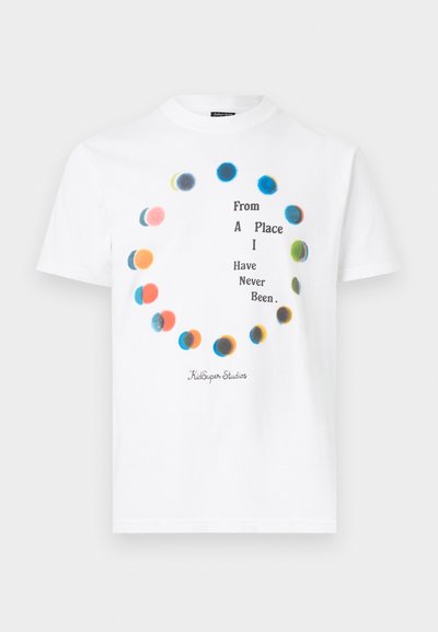 White cotton t-shirt featuring colorful, circular splashes and text in the center: "From A Place I Have Never Been," with brand logo below.