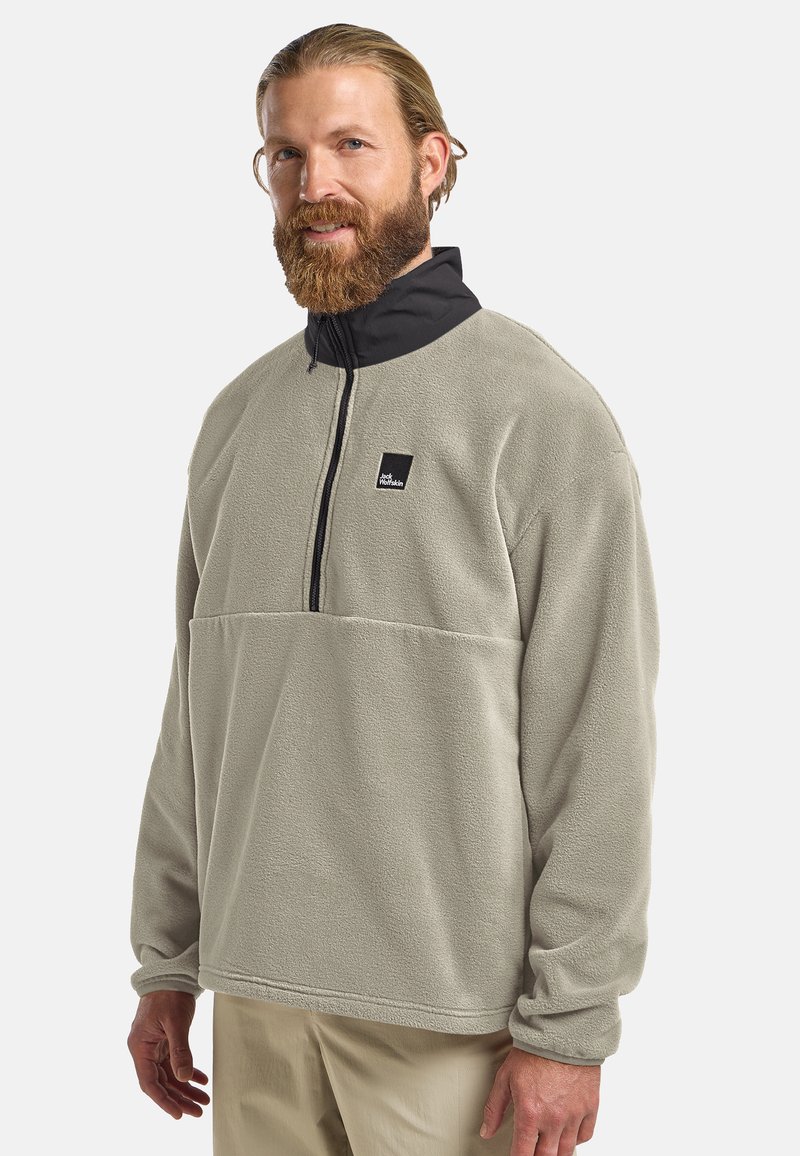Light gray fleece pullover with a black high collar and quarter-zip. Features a chest pocket with a black logo patch. Soft texture.