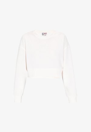 Skraćeni bijeli dukserica od mekanog pamuka. Ima okrugli izrez, duge rukave s rebrastim završetkom i čistu hemiju.