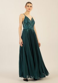 Türkise, plissierte Abendkleid mit V-Ausschnitt, verzierten Oberteil mit Pailletten und dünnen, verstellbaren Trägern. Knöchellang mit einer fließenden Silhouette.