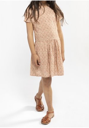 Rosa Kleid mit floralem Muster, kurzen Ärmeln, gerafftem Rock und rundem Halsausschnitt, kombiniert mit braunen Sandalen mit Riemchen.