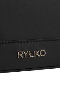 Black leather product featuring a smooth texture, gold embossed logo “RYŁKO,” and stitching along the edge for detail.