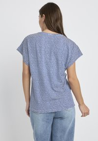 Striped short-sleeve top in blue and white; lightweight fabric; relaxed fit with a rounded hem; side slits for ease of movement.
