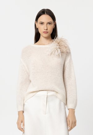 Light beige knitted sweater with a relaxed fit, featuring a textured finish and a large feather accent on the left shoulder.