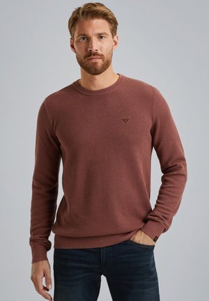 Knitted crewneck sweater in dark rust color, featuring a textured pattern and ribbed cuffs. Small logo accent on the upper chest.