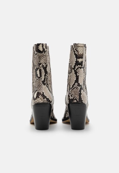 Snake-print ankle boots with a textured finish, black heels, and pointed toes. Features a distinctive reptilian pattern in beige and black.