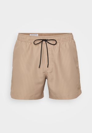 Beżowe kąpielówki w pionowe paski, elastyczny pas i regulowany czarny sznurek. Lekki materiał o gładkiej teksturze.