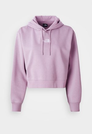 Haut cropped en violet clair, fabriqué en tissu doux. Présente une poche avant et des cordons de serrage réglables, avec un logo blanc sur la poitrine.