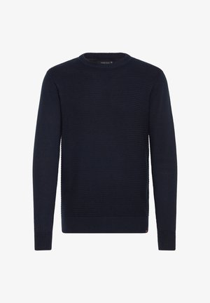 Tamsiai mėlynas megztinis su gumine tekstūra, apvaliu kaklu ir ilgomis rankovėmis. Hemas ir rankogaliai yra su guma, kad užtikrintų struktūrą.