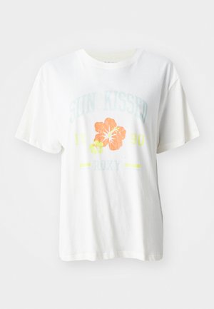 Bela bomba iz bombaža z grafičnim potiskom tropskih cvetov v oranžni in rumeni barvi ter napisom "SONČNO POLJUBLJEN 1990 Roxy."