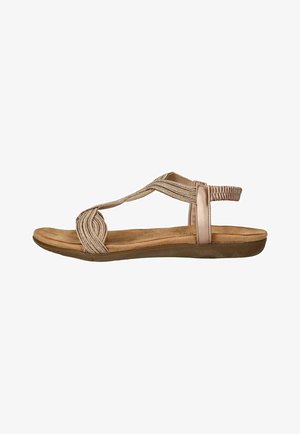 Dames platte sandaal met een beige gewatteerde zool, beige elastische bandjes die over de voet kruisen, en een elastische achterriem voor een veilige pasvorm.