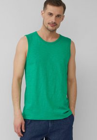 Grünes ärmelloses Baumwoll-Top mit rundem Halsausschnitt und lässiger Passform. Weiche Textur mit einem dezenten Melange-Muster.