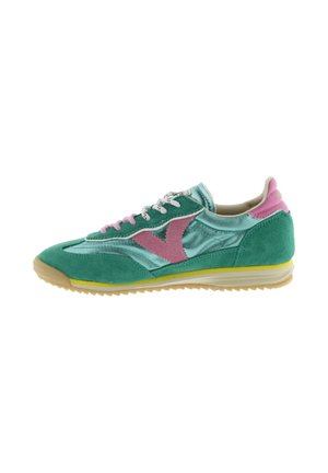 Green and teal athletic shoe with pink accents, white laces, and a yellow-trimmed sole, displayed in a side profile on white background.