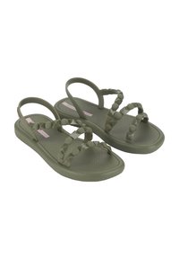 Zielone plastikowe sandały z ćwiekowanymi paskami i teksturowaną wkładką. Wąskie paski na kostkę oraz elastyczna podeszwa. Casualowy design dla wygody.