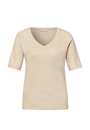 T-shirt beige à manches courtes avec col en V, coupe décontractée et étiquette à l'intérieur du col sur fond blanc.