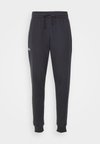 RIVAL FLEECE - Pantaloni de trening - black/white