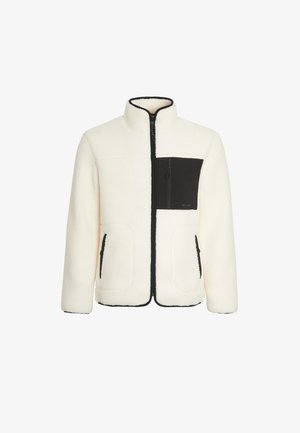 Weiße Fleecejacke mit einer schwarzen, mit Reißverschluss versehenen Brusttasche und seitlichen Taschen. Sie verfügt über einen Stehkragen und kontrastierende schwarze Kanten.