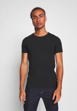 Svart kortermet t-skjorte laget av myk bomull, med rund hals og en tettsittende design. Ingen synlige mønstre eller detaljer.