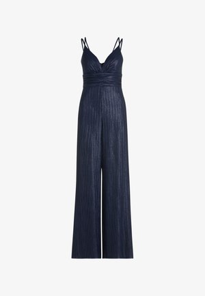 Tuta blu navy con scollo a V e sottili spalline a spaghetti. Presenta costine verticali e pantaloni a gamba larga per una silhouette fluida.